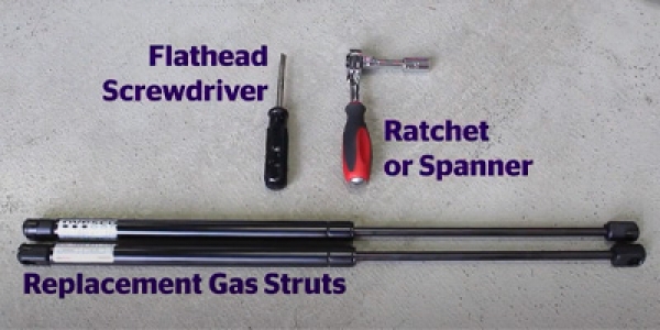 A flat head screwdriver, ratchet and pair of replacement gas struts.